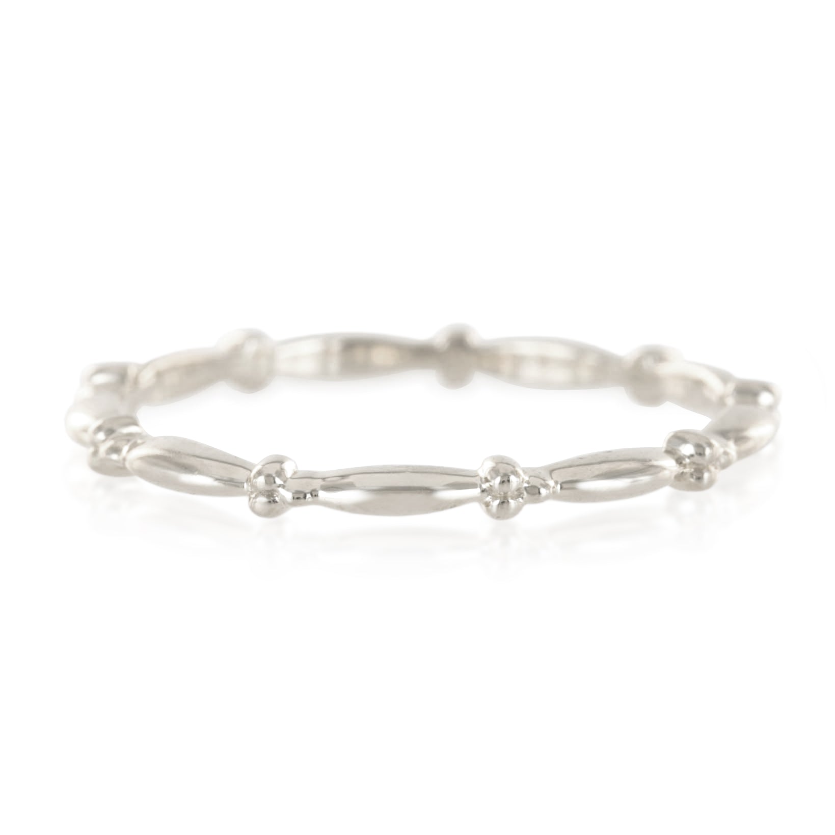 Close-up of a delicate 14k white gold beaded stacking ring with alternating smooth and beaded sections.