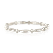 Close-up of a delicate 14k white gold beaded stacking ring with alternating smooth and beaded sections.