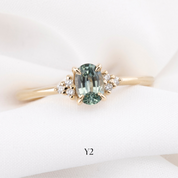 Gold ring with a green gemstone on a white background
