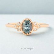 Celine Ring featuring a 0.60ct teal-blue Montana sapphire in a 14k rose gold with six natural diamond accents