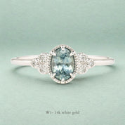 Celine Ring featuring a 0.60ct teal-blue Montana sapphire in a 14k white gold with six natural diamond accents