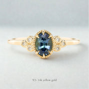 Celine Ring featuring a 0.60ct teal-blue Montana sapphire in a 14k yellow gold with six natural diamond accents