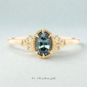 Celine Ring featuring a 0.60ct teal-blue Montana sapphire in a 14k yellow gold with six natural diamond accents