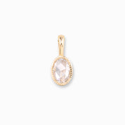 Gold pendant with a clear gemstone on a white background