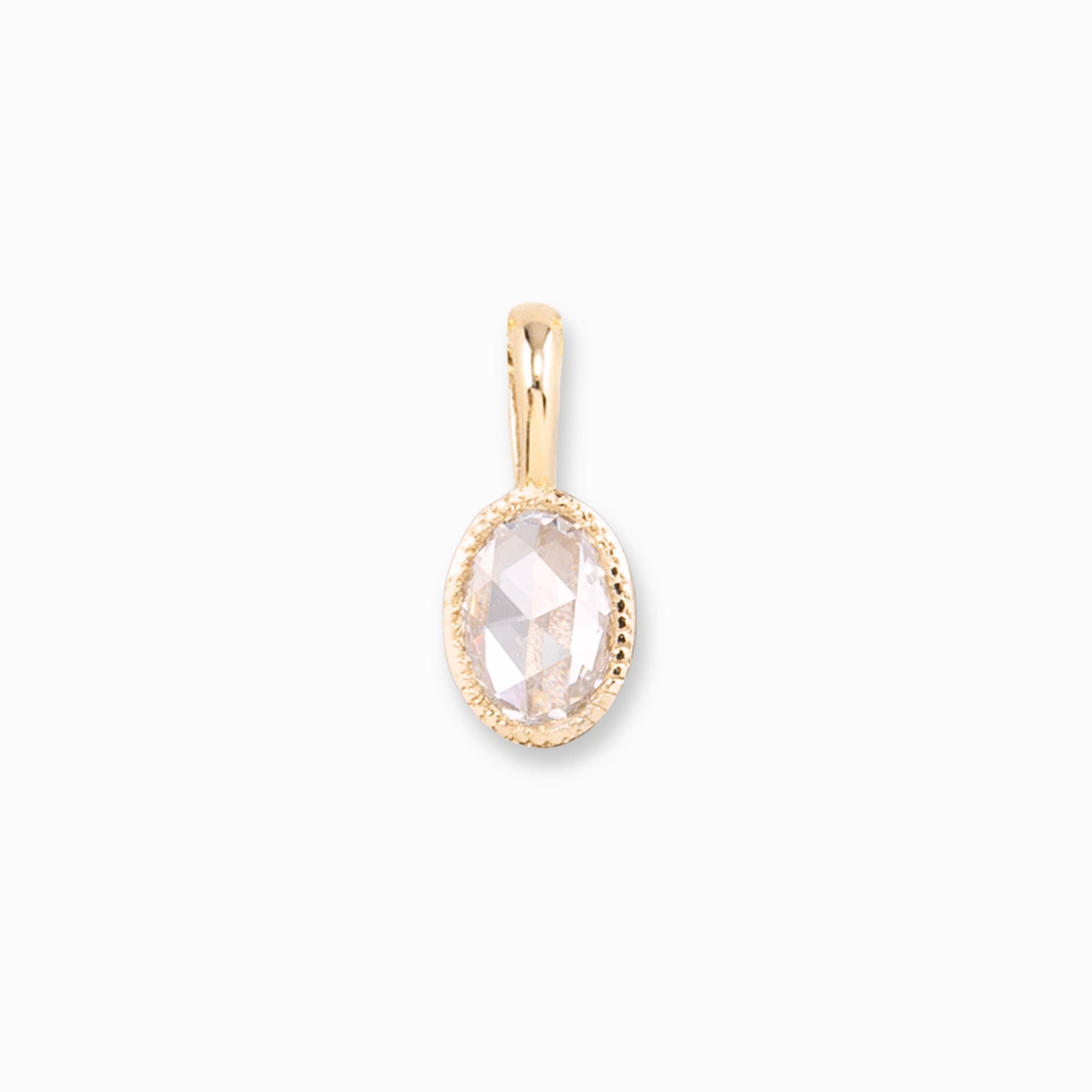 Gold pendant with a clear gemstone on a white background