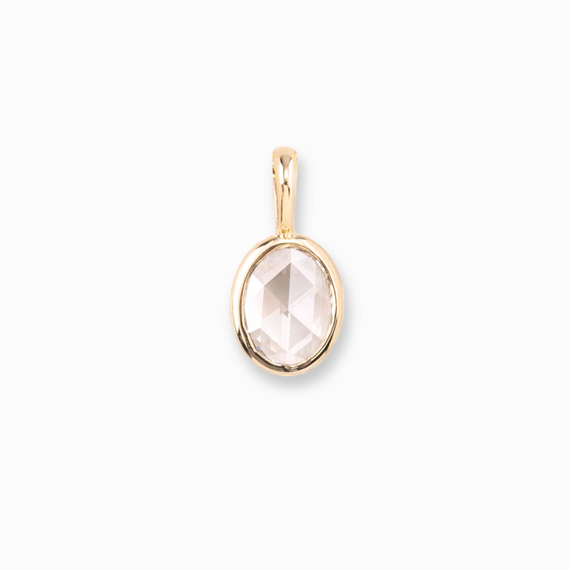 Gold pendant with a clear gemstone on a white background