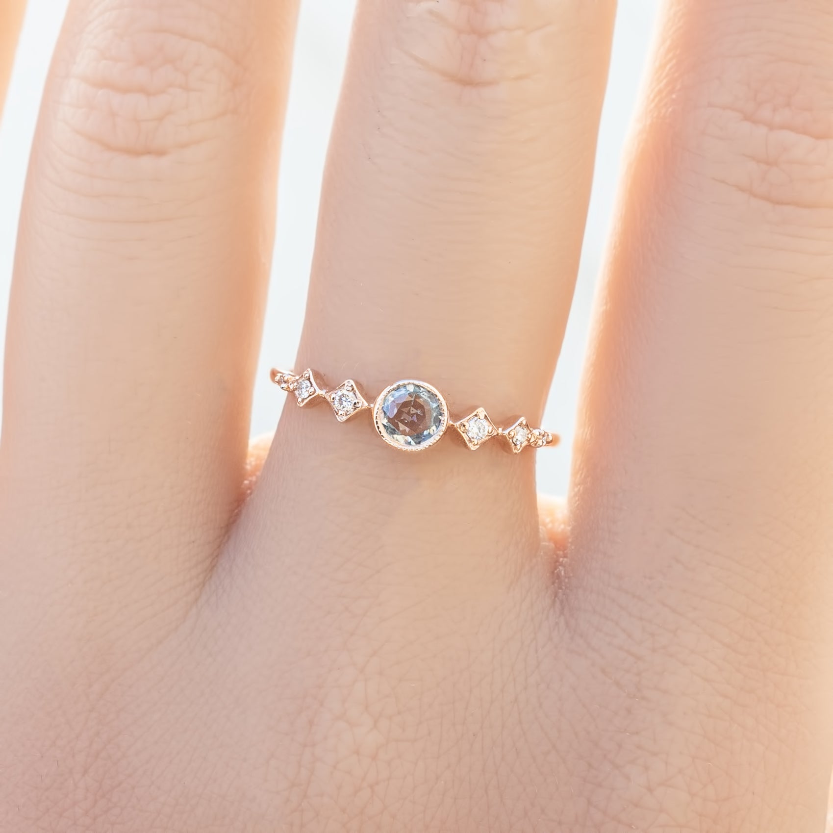 Celeste Ring, 0.25ct Unheated Sapphire in 14k rose gold setting on a hand