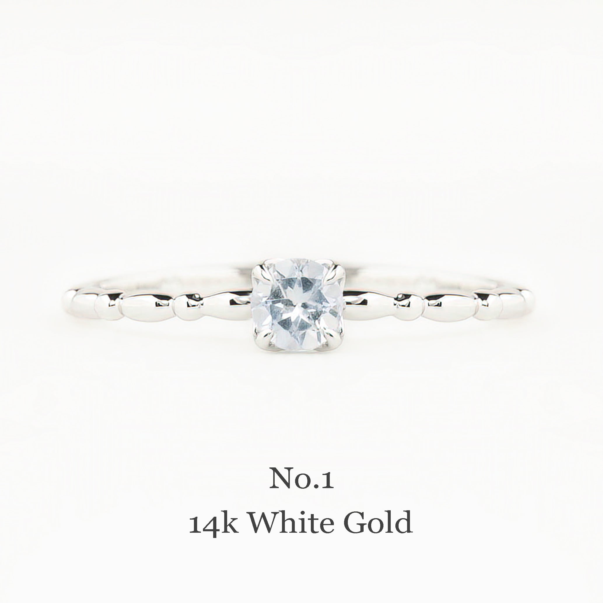 14k white gold ring with a diamond on a white background