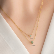 Comparison of 3.0mm Light Blue Green Sapphire Pendant Necklace next to 4.0mm Green Sapphire Pendant Necklace in 14k yellow gold on a model