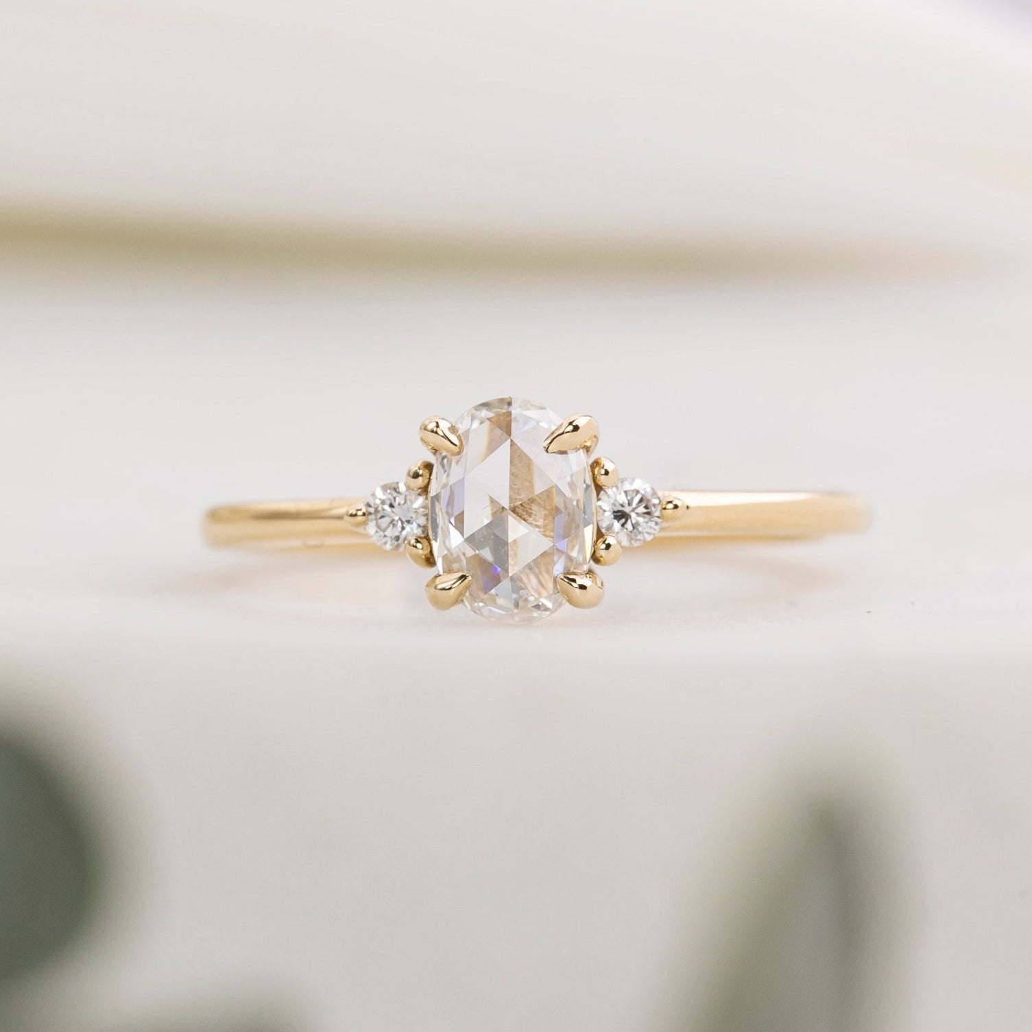 Gold ring with a diamond on a blurred background