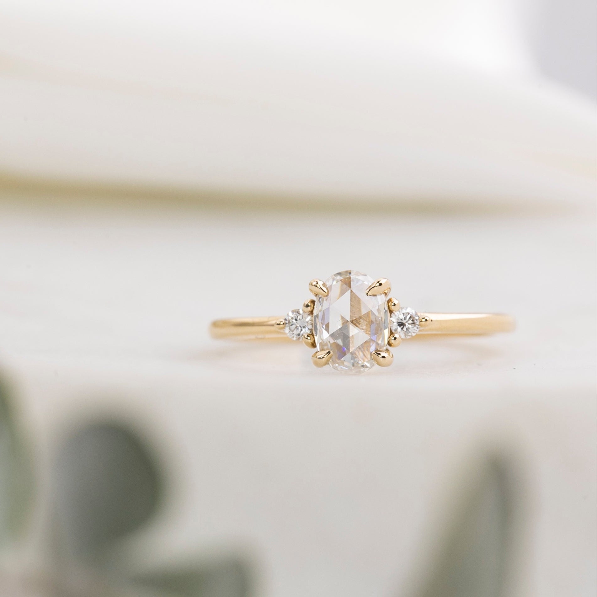 Gold ring with a diamond on a blurred background