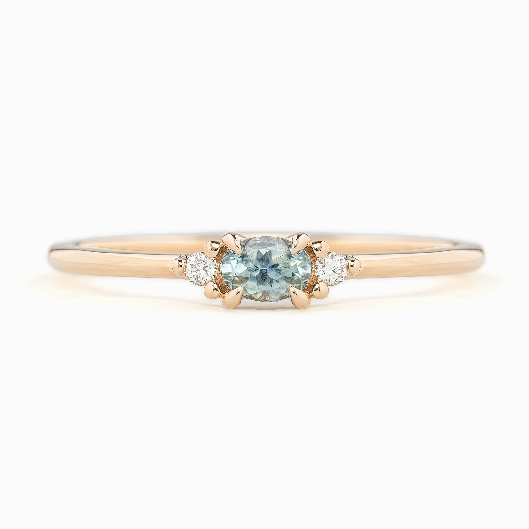 Emilie Ring featuring a 0.20ct East-West set oval Montana sapphire in 14k rose gold.