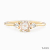 Gold ring with a central diamond and smaller diamonds on a white background