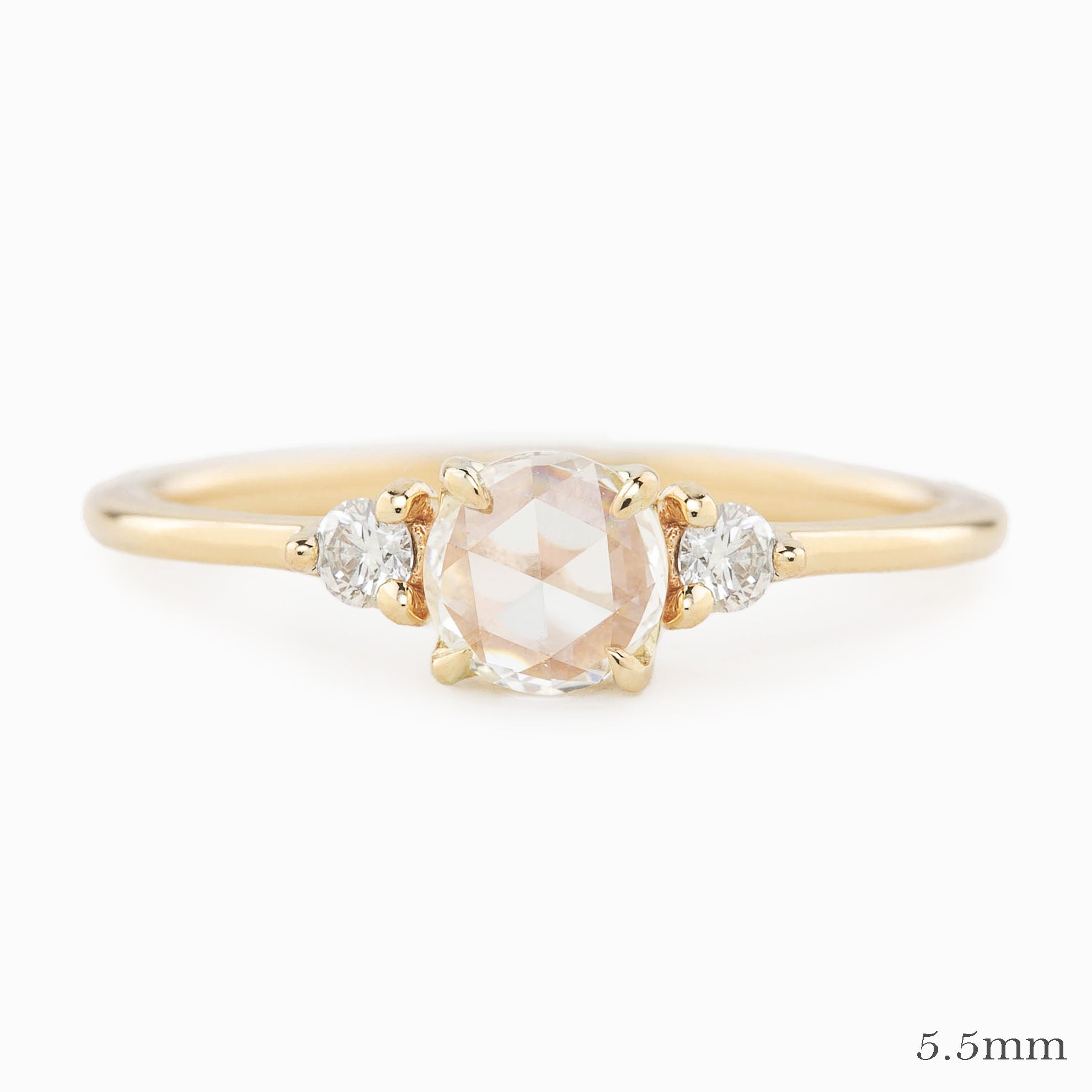 Gold ring with a central diamond and smaller diamonds on a white background