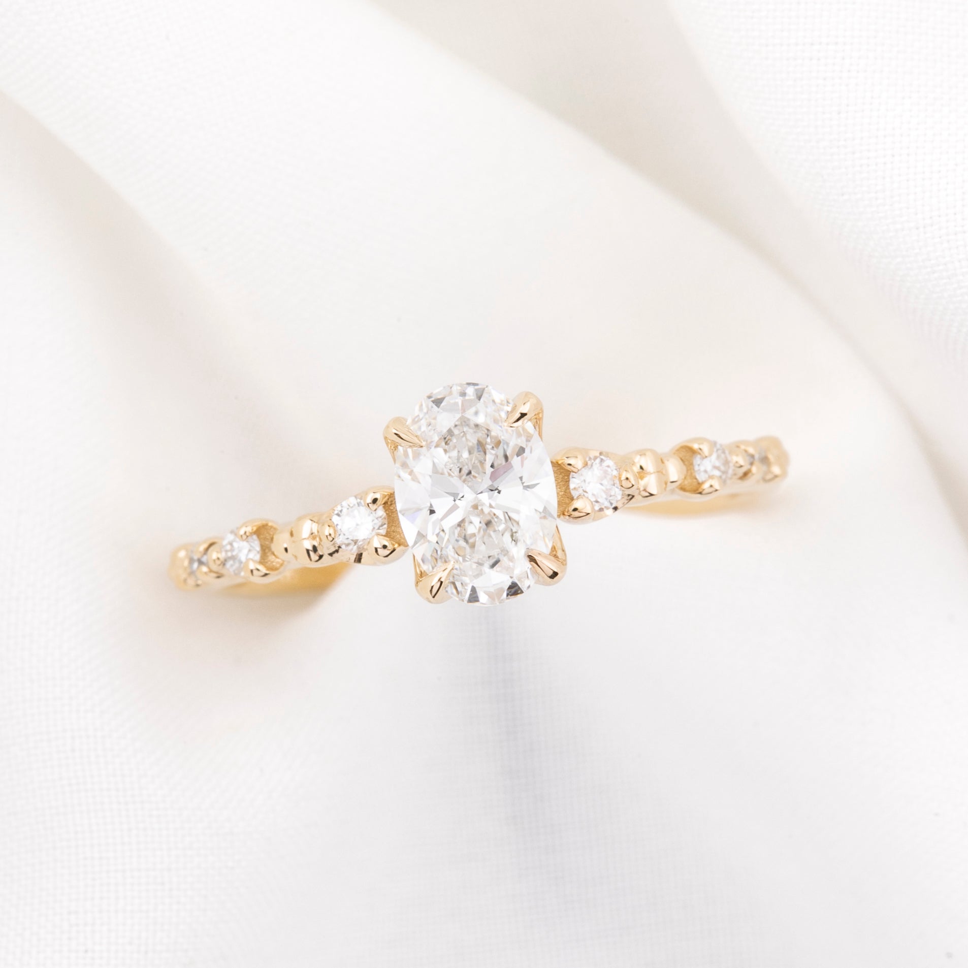 Wisteria ring 0.7ct oval diamond