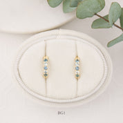 14K yellow gold Montana sapphire huggie earrings with blue sapphires, 12.5mm