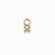 Gold pendant with a clear gemstone on a white background
