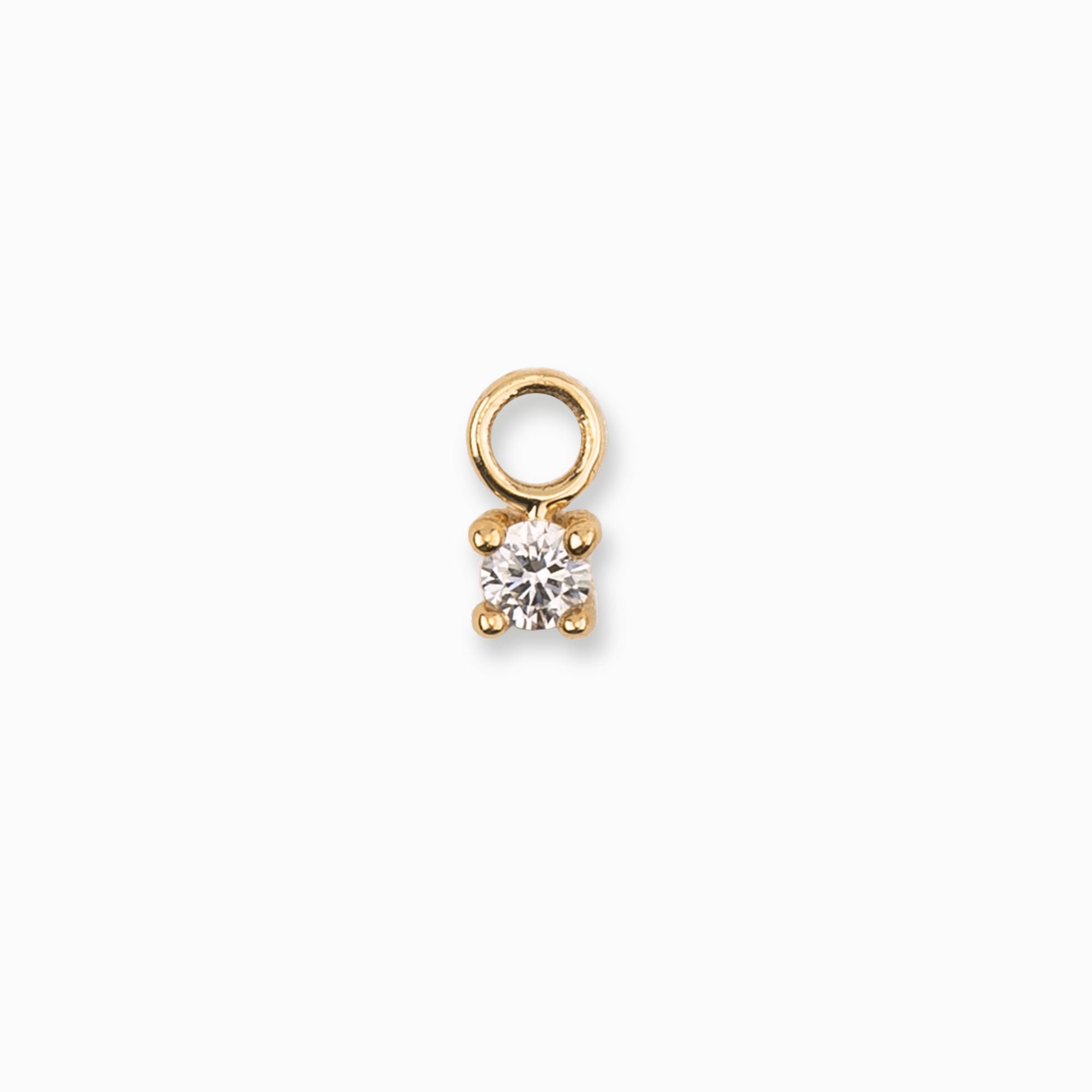 Gold pendant with a clear gemstone on a white background