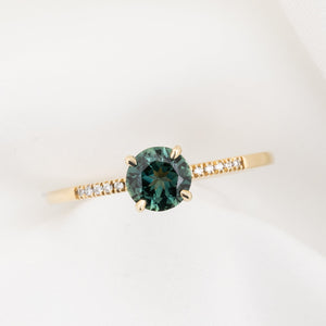 Audrey Ring, 0.73ct Queensland Sapphire with a green gemstone on a white background
