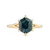 Gold ring with a green gemstone on a white background