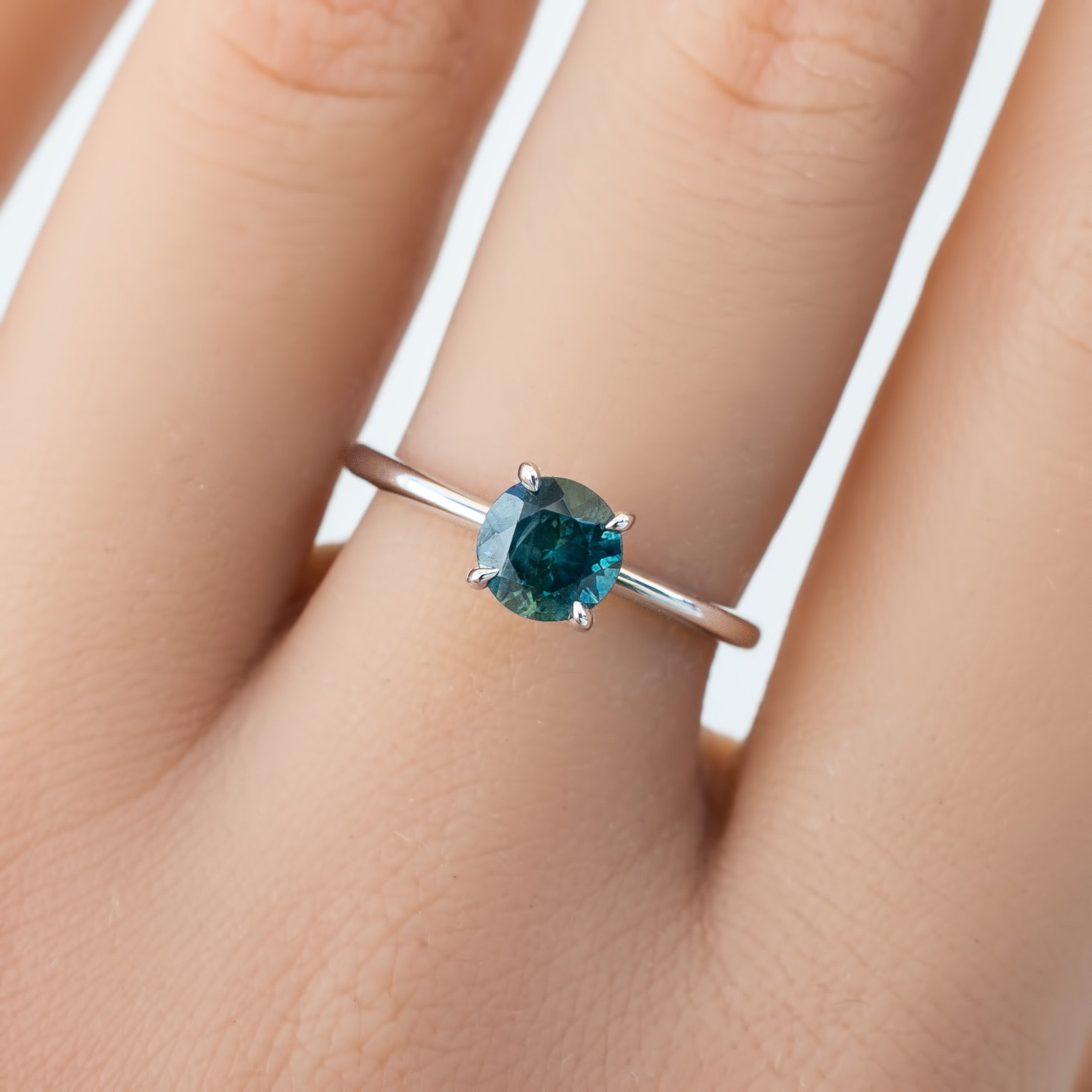 Close-up of Jane Ring with 1.18ct blue-green Montana sapphire in a classic four-prong solid gold setting