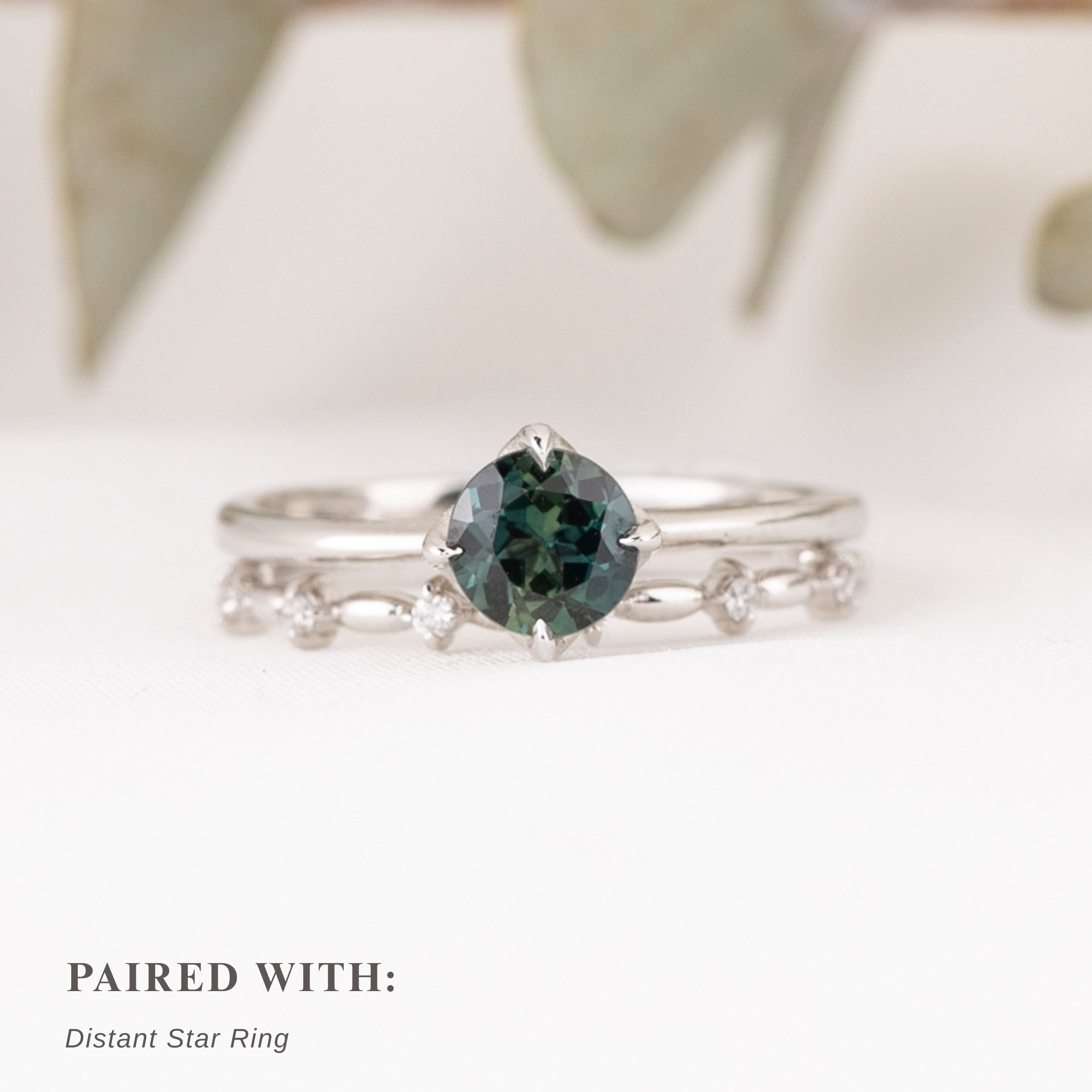 Alice Ring, 0.85ct Queensland Sapphire ring with a green gemstone on a white background