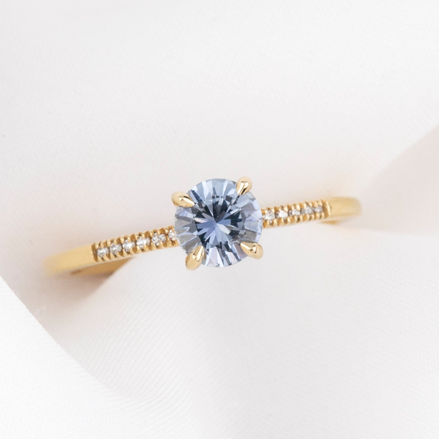 Audrey Ring featuring a 0.70ct Montana Sapphire set in a delicate gold band with small accent stones on Etsy.