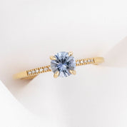 Audrey Ring featuring a 0.70ct Montana Sapphire set in a delicate gold band with small accent stones on Etsy.