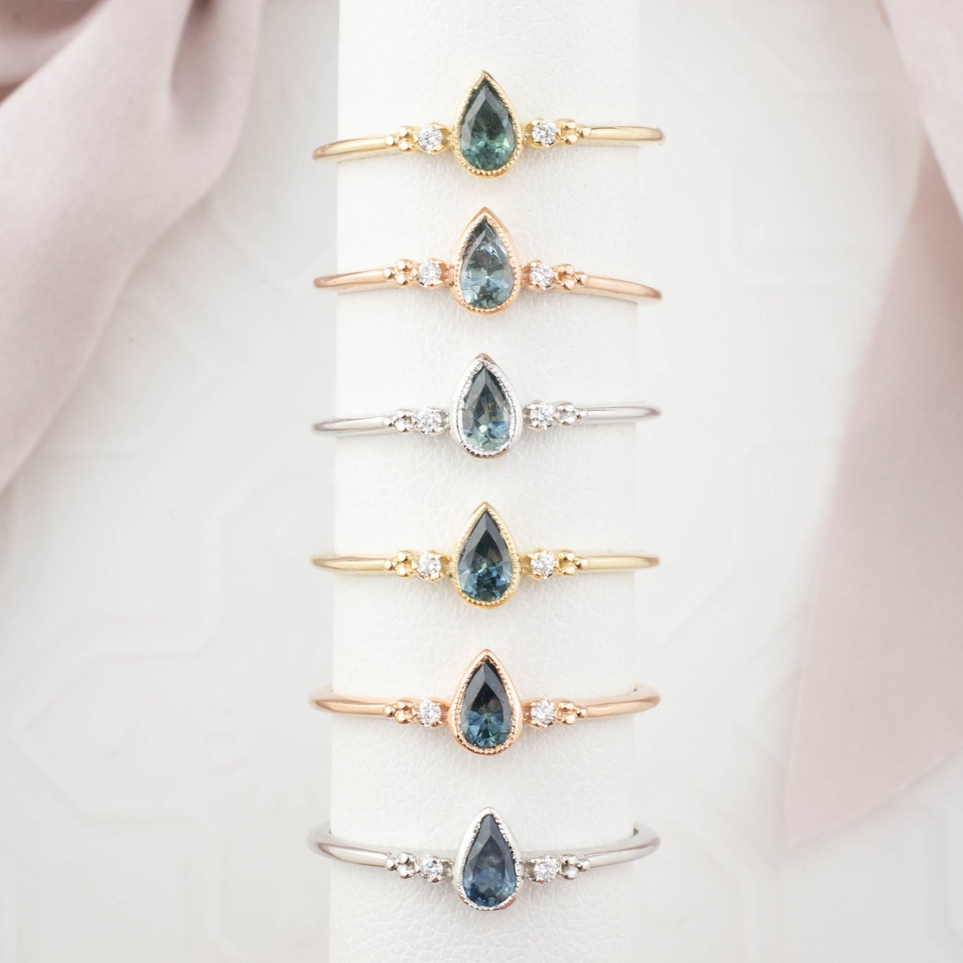 Six Estel Bezel Ring with a 0.35ct unheated teardrop sapphire and two natural diamond accents in 14k gold.