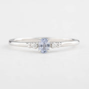Silver ring with a blue gemstone on a white background