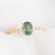 14k gold ring featuring a 1.27ct Montana oval sapphire with diamond side stones—timeless sparkle with an elegant silhouette.