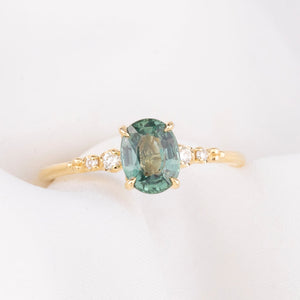 14k gold ring featuring a 1.27ct Montana oval sapphire with diamond side stones—timeless sparkle with an elegant silhouette.