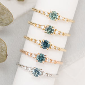 Six unique Estel Fleur rings featuring 0.40ct Montana sapphires in yellow, rose, and white gold.