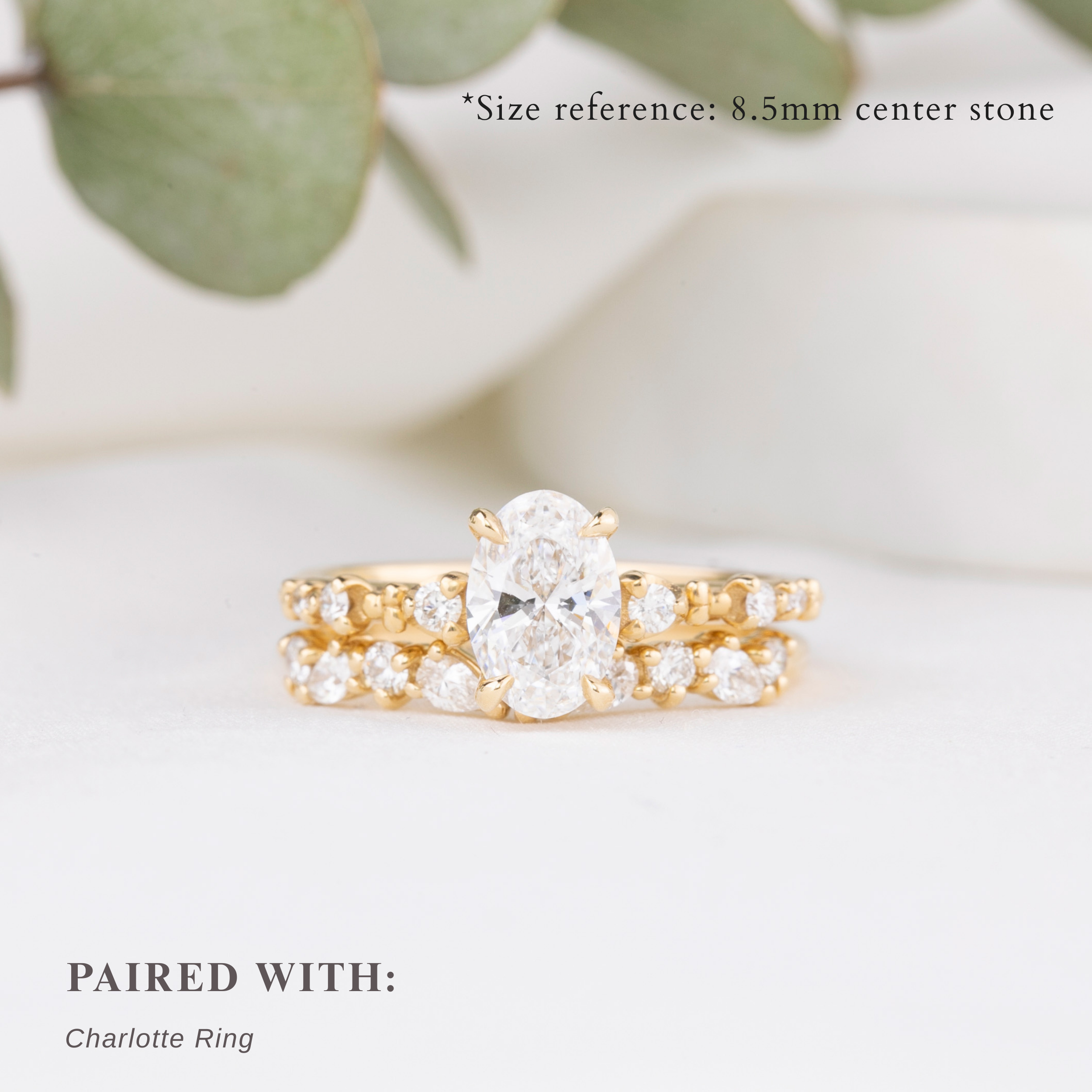 Gold ring with a central diamond and smaller diamonds on a light background