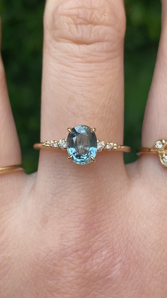 14k gold ring featuring a 1.27ct Montana oval sapphire with diamond side stones—timeless sparkle with an elegant silhouette.