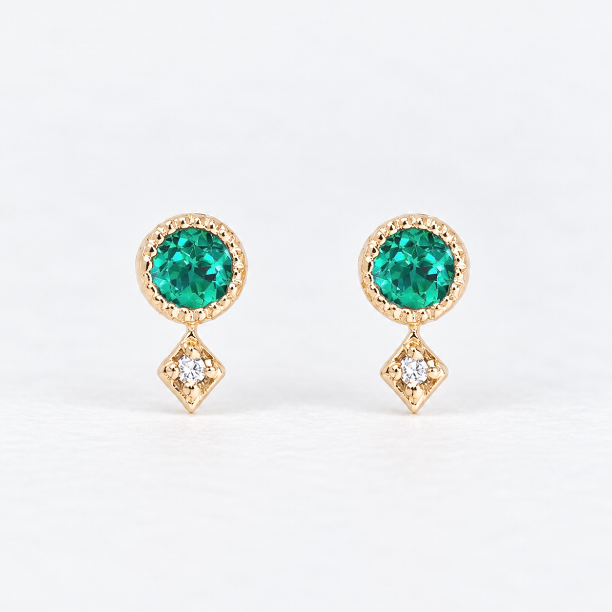 14K yellow gold stud earrings with round green gemstones and natural diamond accents