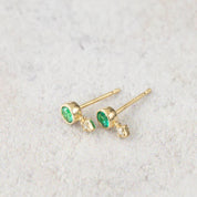 14K yellow gold stud earrings with round green gemstones and natural diamond accents