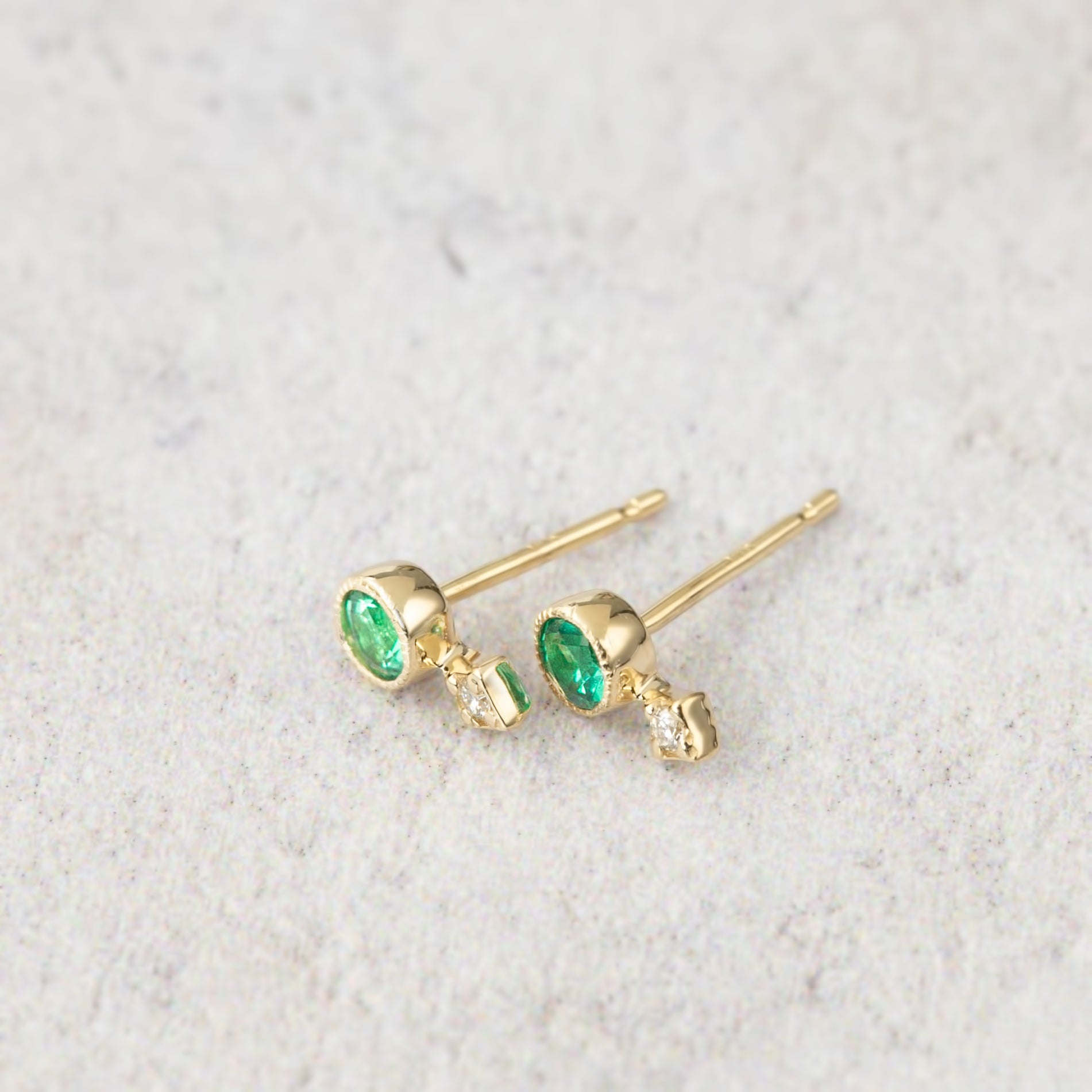 14K yellow gold stud earrings with round green gemstones and natural diamond accents
