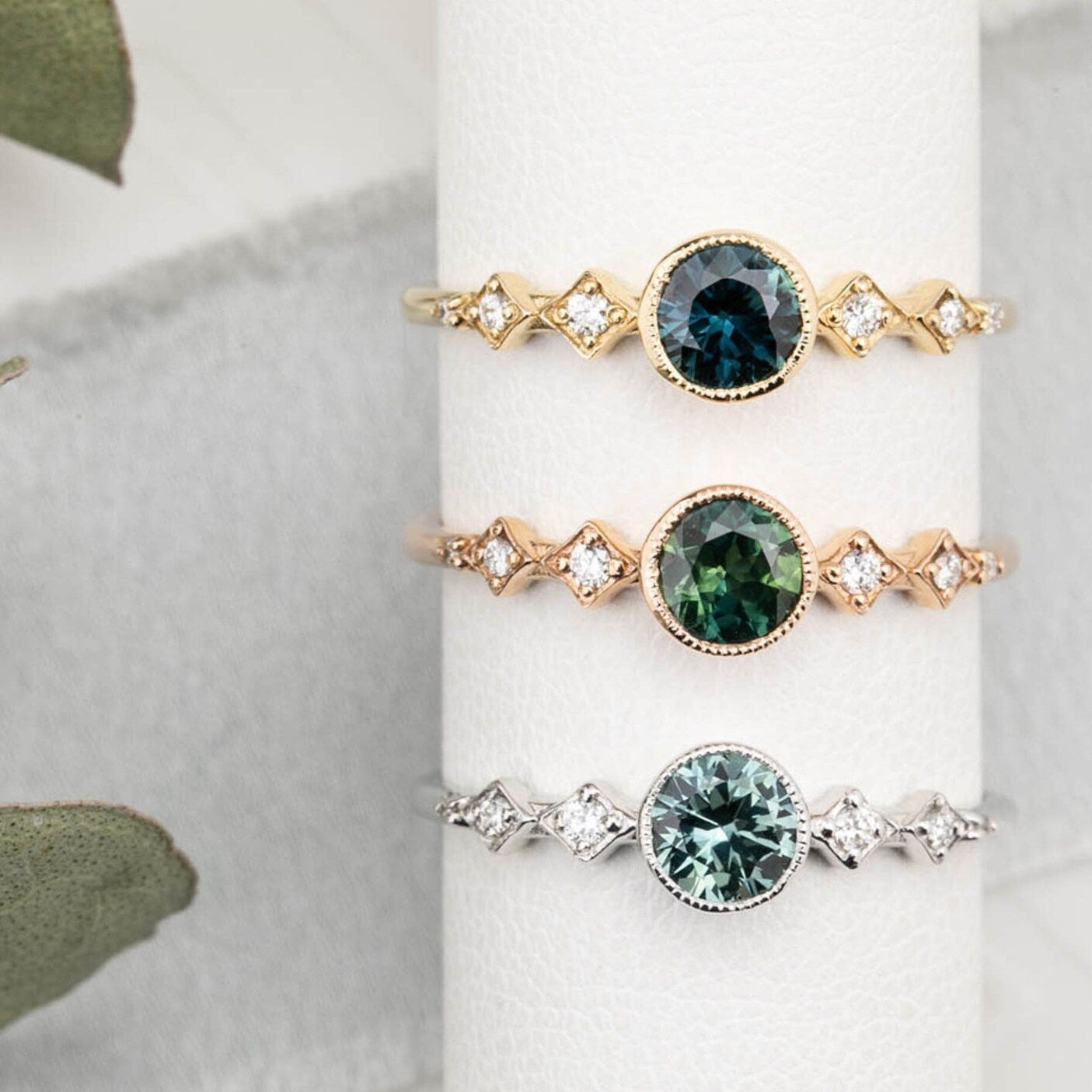 3 0.50ct Queensland Sapphire Ring in 14k yellow gold, rose gold and white gold. DIfferent shades of blue green sapphires.