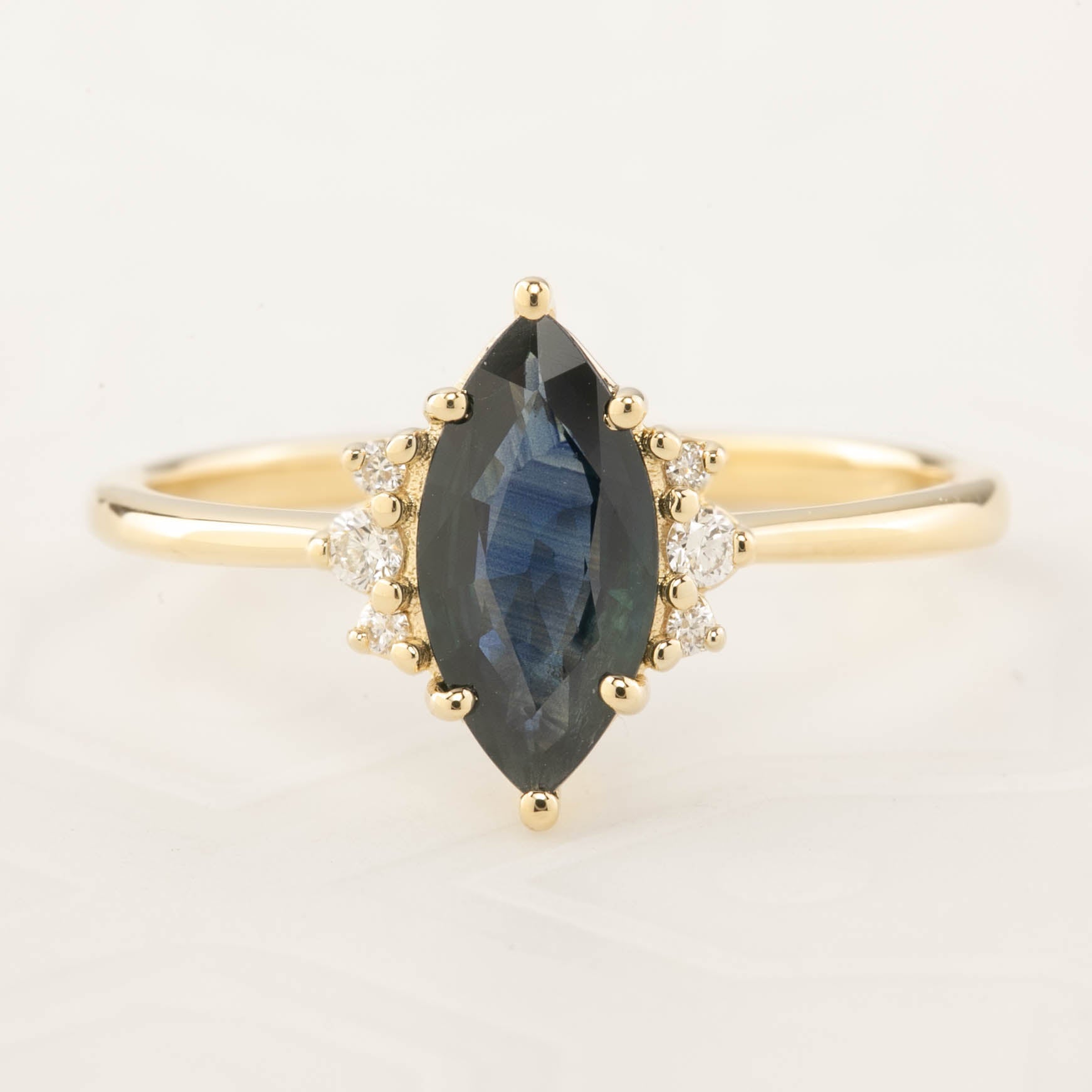 Lena Ring with 0.94ct marquise dark blue green sapphire and white accent diamonds in recycled 14k gold