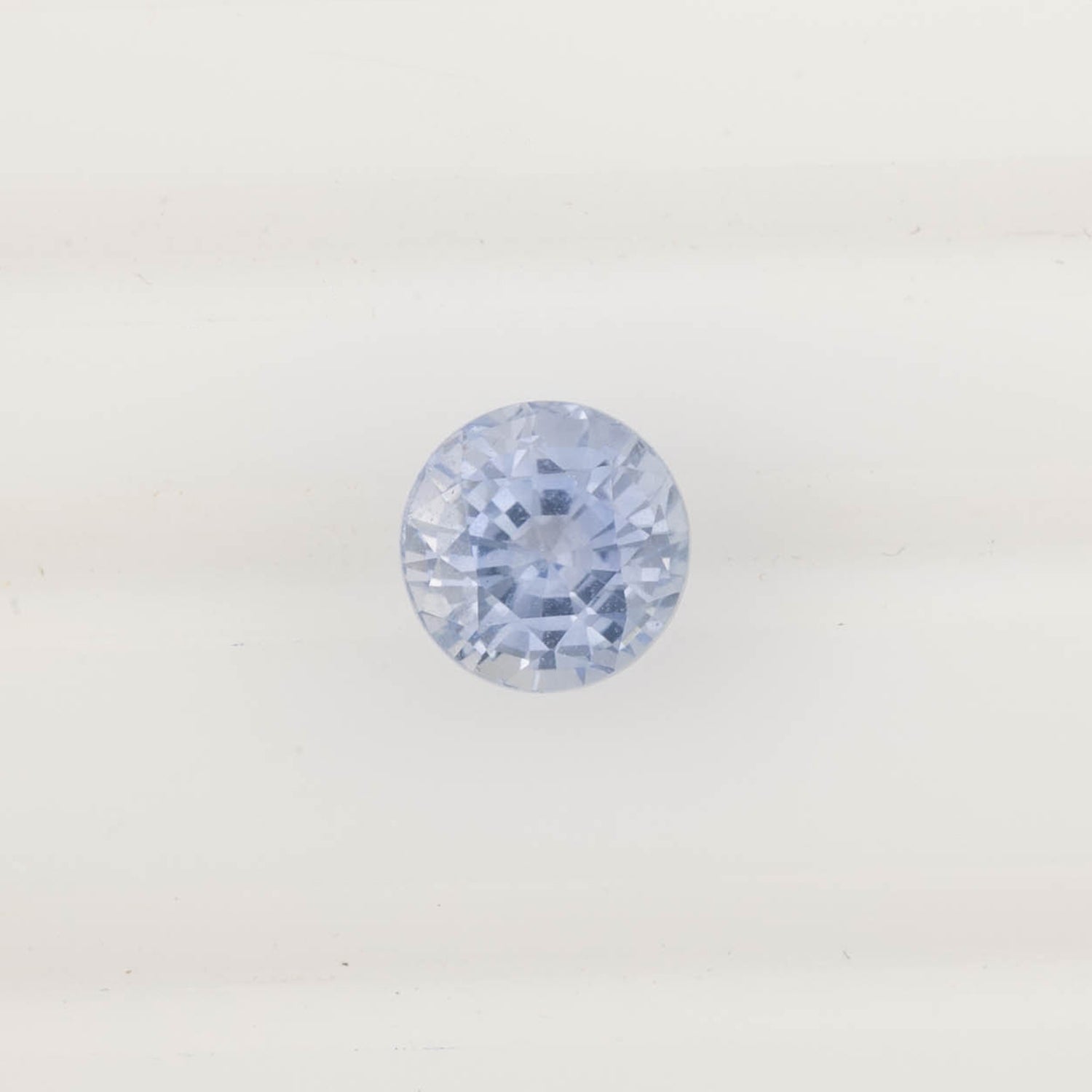 2.06ct round cut Ceylon blue sapphire with light blue color and eye-clean clarity, ethically sourced from Sri Lanka