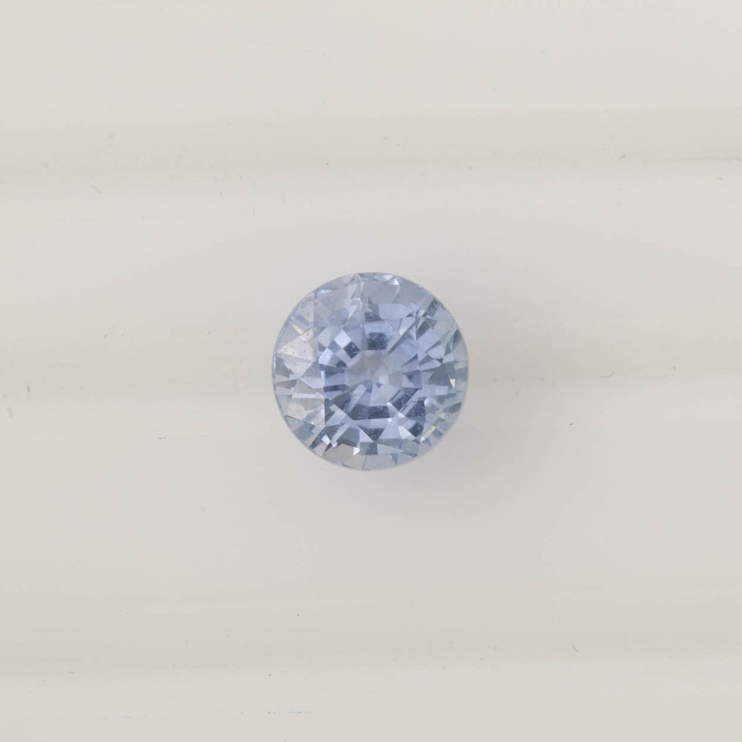 2.06ct Round Cut Ceylon Blue Sapphire with light blue color and eye-clean clarity, ethically sourced from Sri Lanka.
