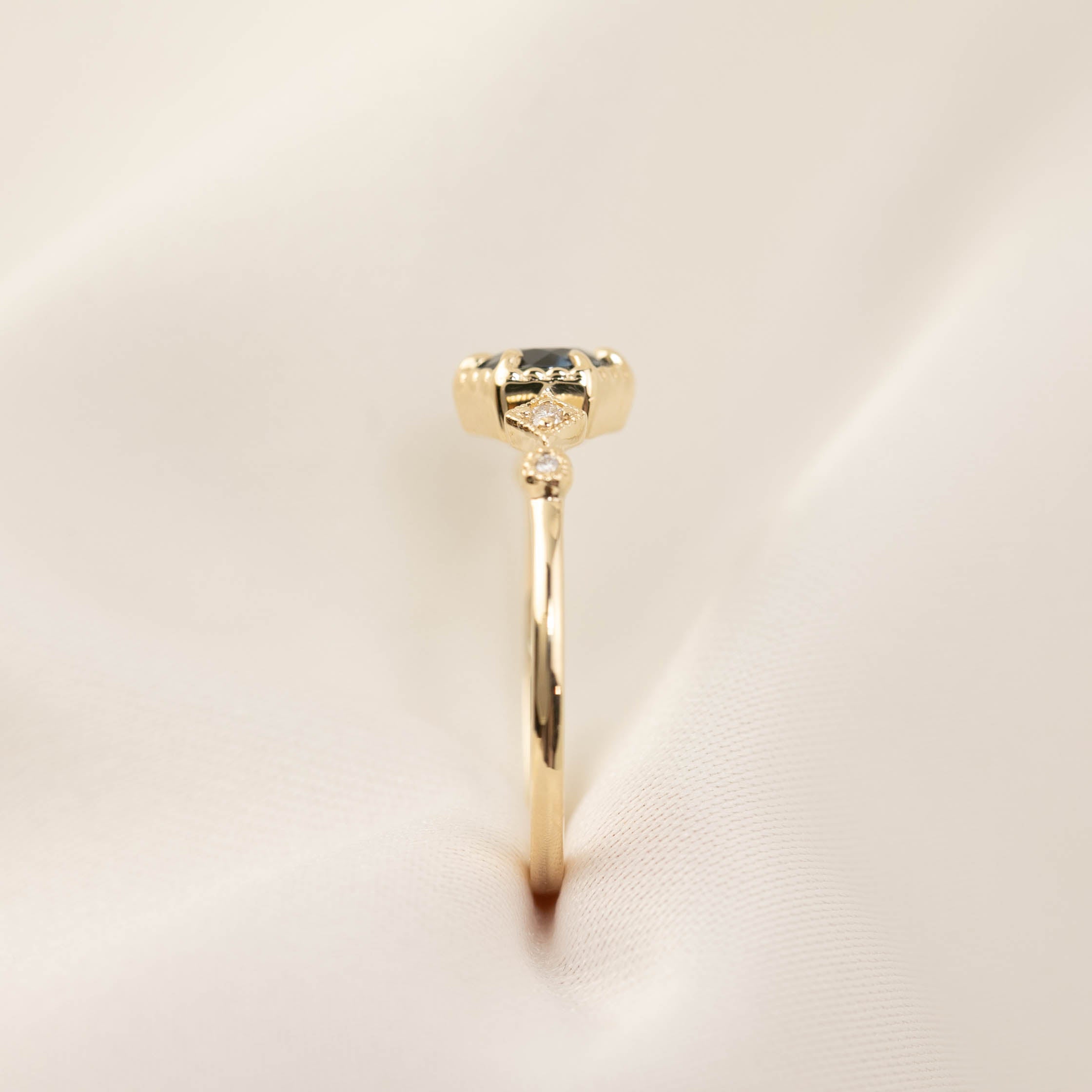 Side view of Stella Ring featuring 0.7ct Queensland sapphire and white diamonds in 14k gold band