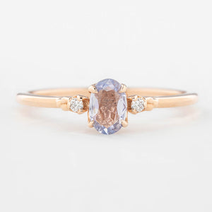 Three 'Estel Rings' with oval-shaped sapphires, in settings of 14k rose gold, 14k white gold, and 14k yellow gold, displayed against a light background., oval shape gemstone