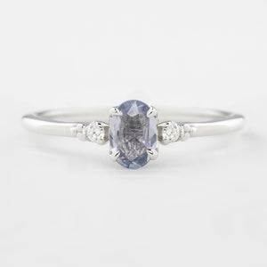 Three 'Estel Rings' with oval-shaped sapphires, in settings of 14k rose gold, 14k white gold, and 14k yellow gold, displayed against a light background., oval shape gemstone