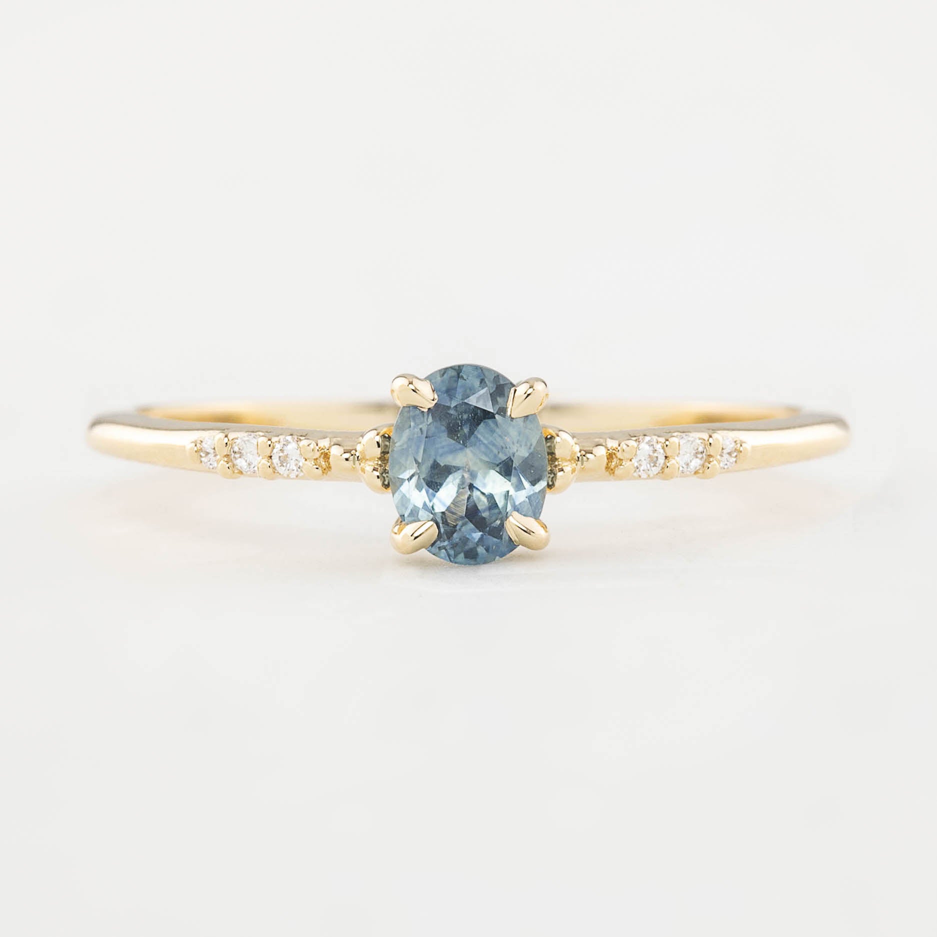 Eloise Ring with a 0.45ct oval Montana sapphire and diamond pave band in 14k yellow gold
