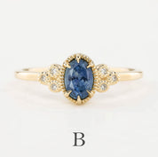 A blue Montana Sapphire ring with small accent diamonds set in a 14k yellow gold band, displayed against a white background.