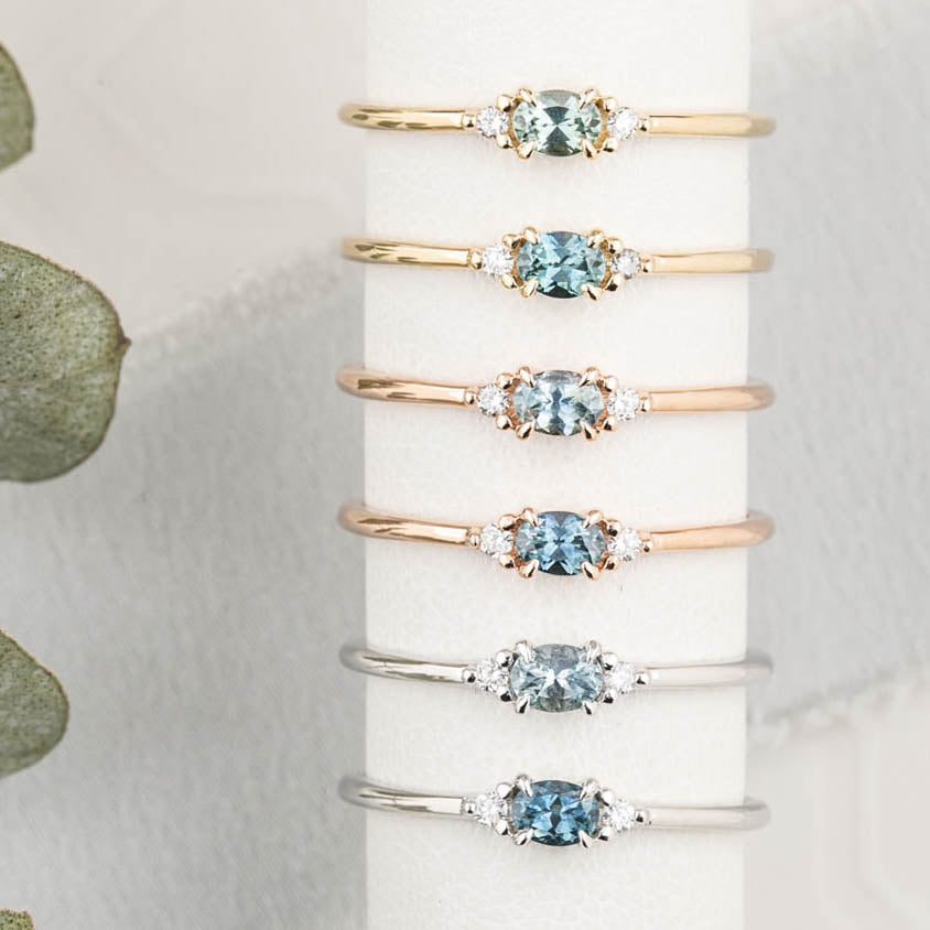 SIx different Emilie Rings featuring a 0.20ct East-West set oval Montana sapphire.