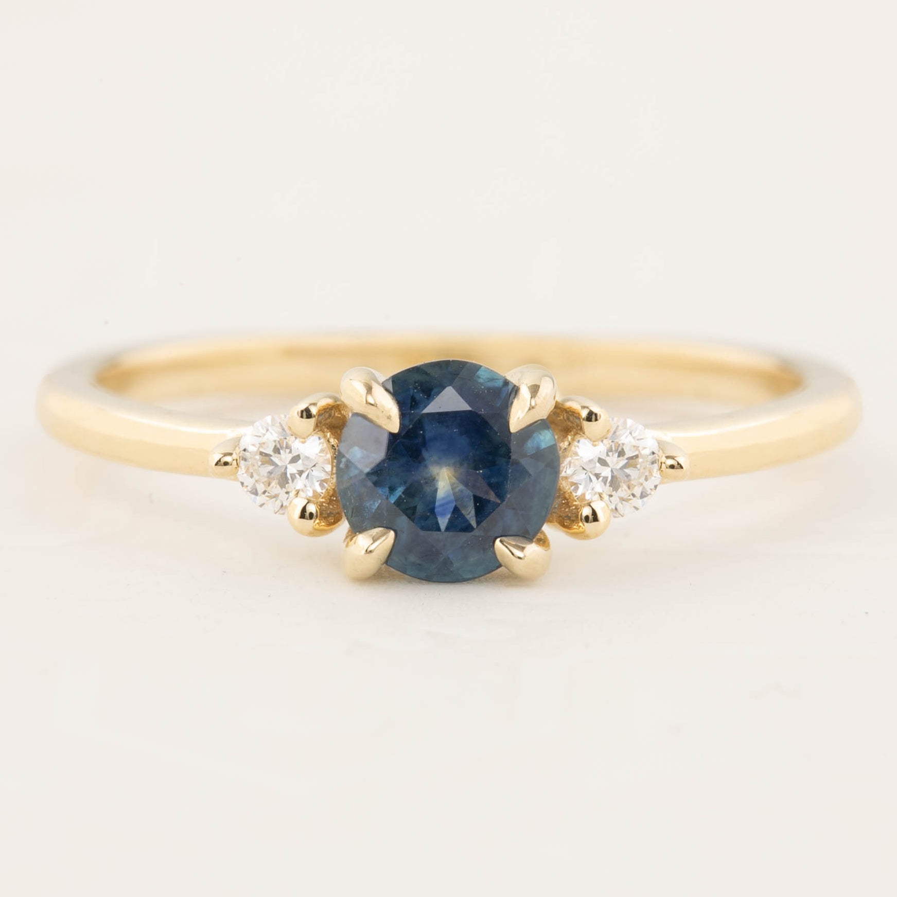 Emilie Ring with 0.71ct blue green Montana sapphire and ethically sourced diamonds in 14k yellow gold band