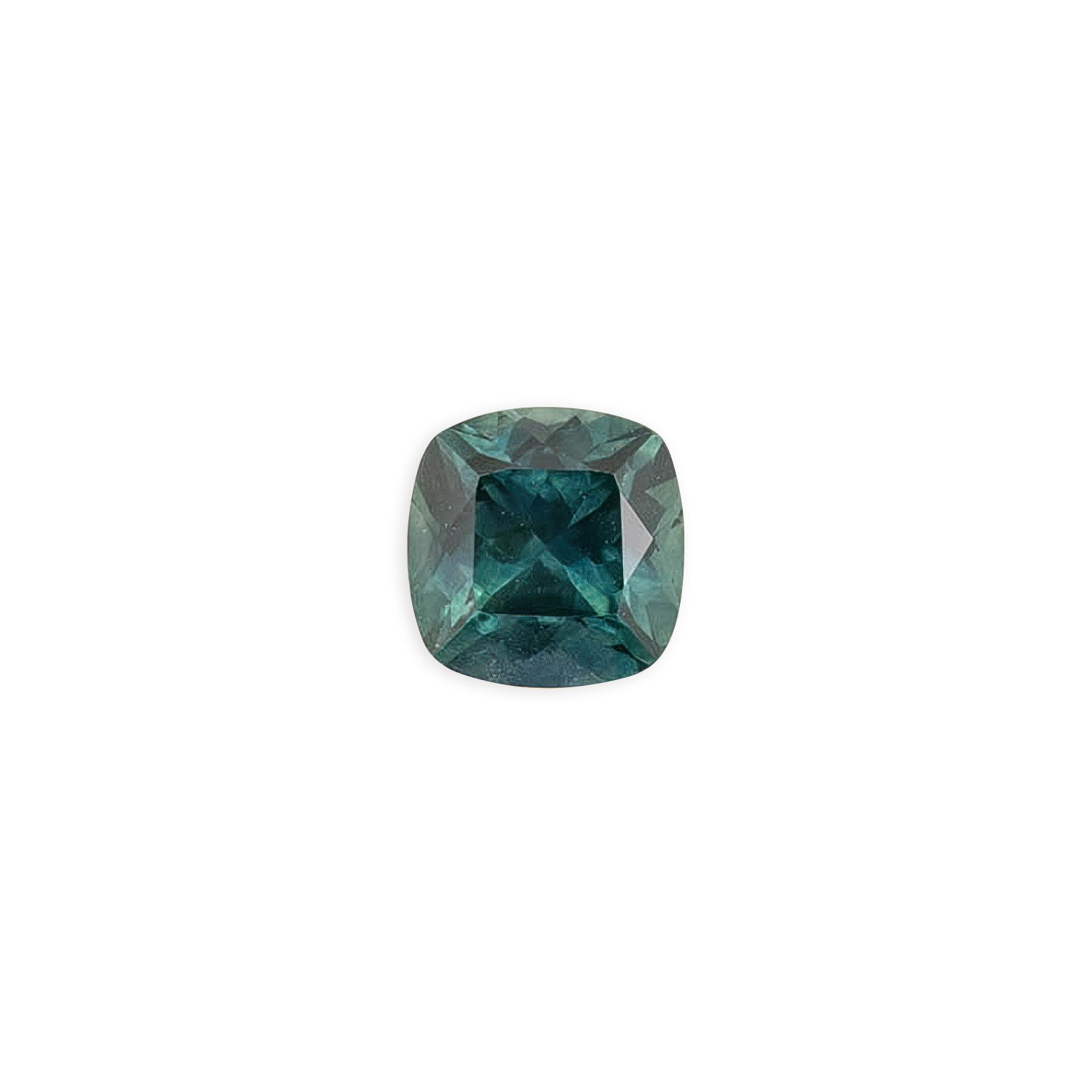 1.42ct cushion cut Montana sapphire with teal blue and peacock green hues, polished and sparkling under light.